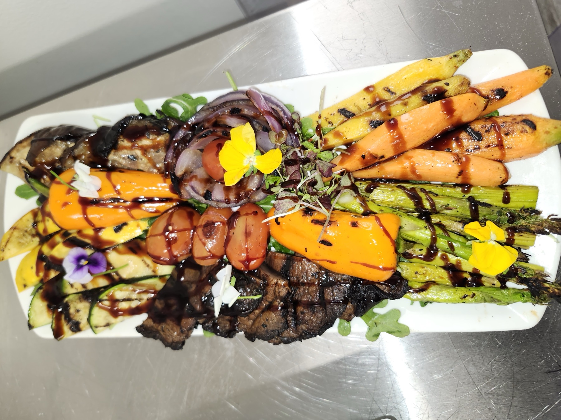 A grilled vegetable and steak platter by Jose's Kitchen