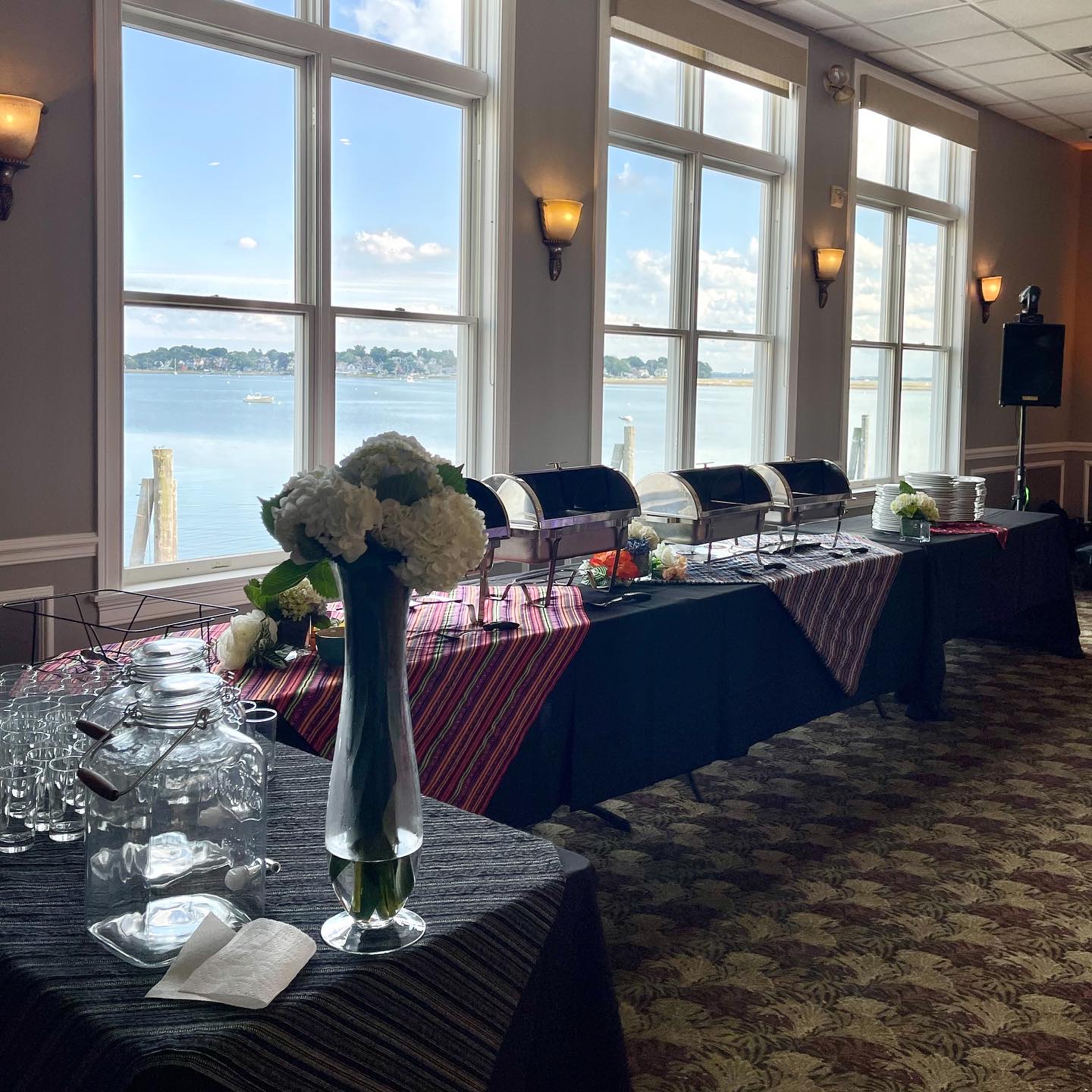 The function hall set for an event, buffet line along the harbor windows