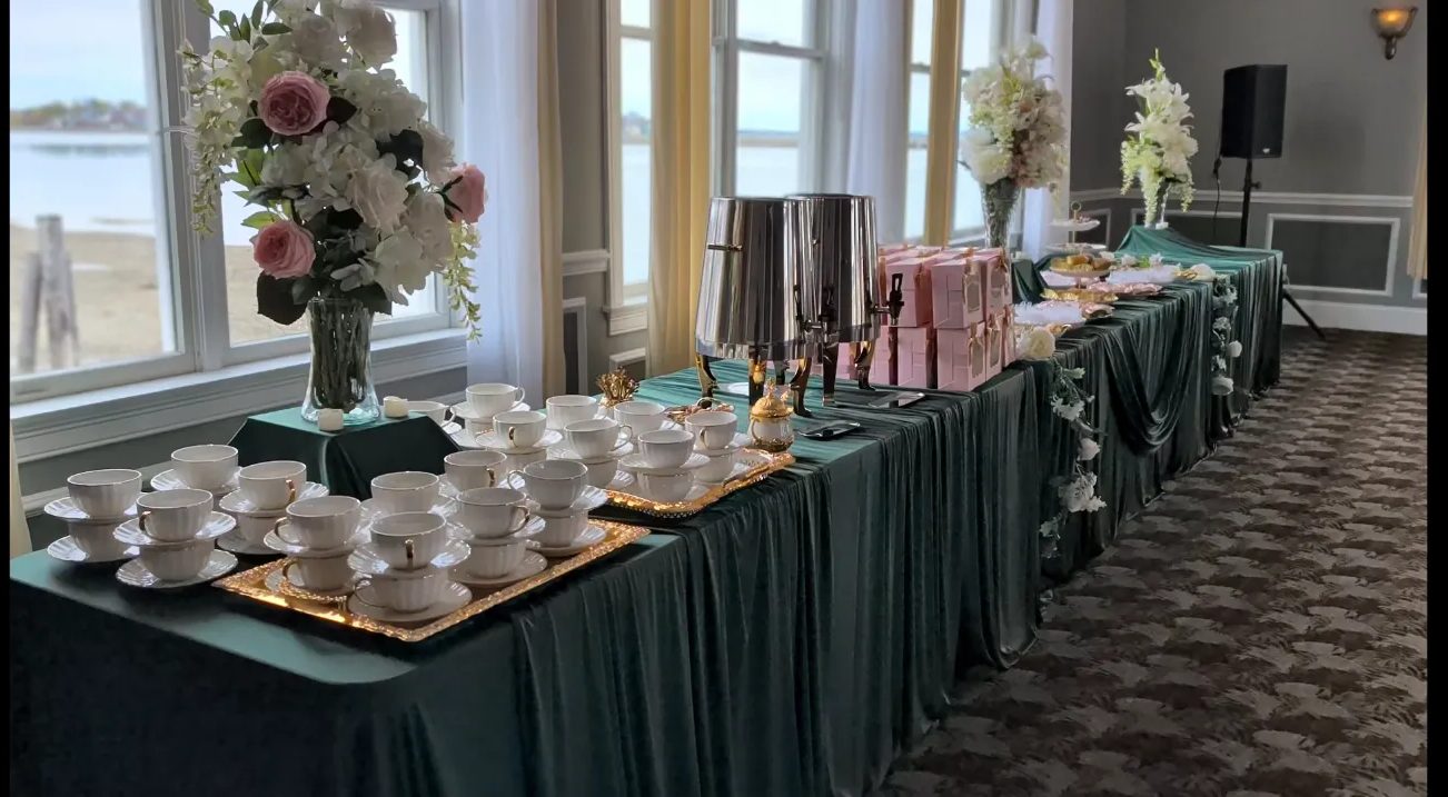 Tea and dessert service with a harbor view