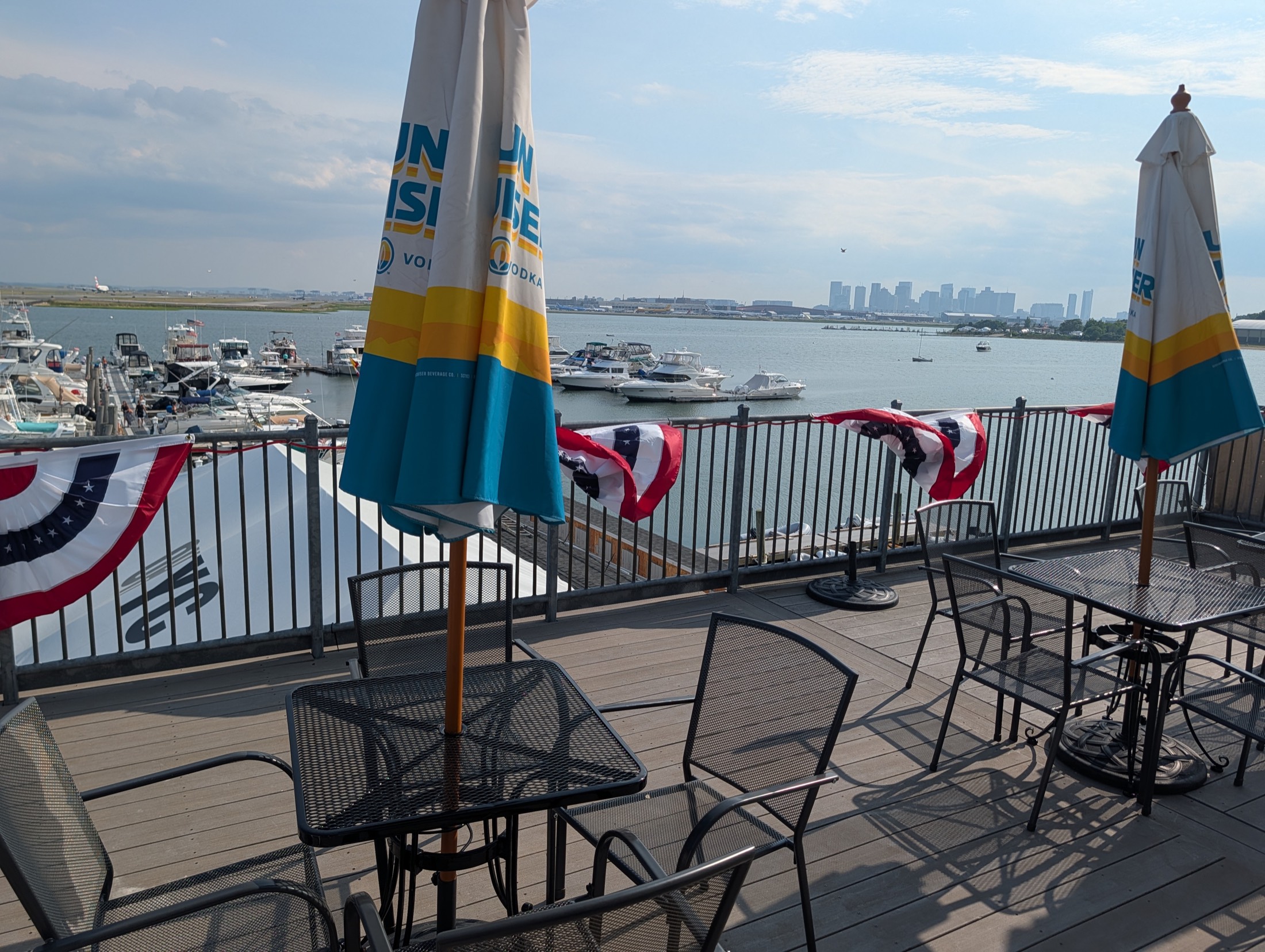 The members' deck, Boston skyline and the marina beyond the rail